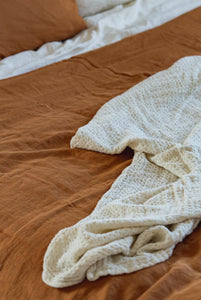 Beige Linen Blanket on brown bedding