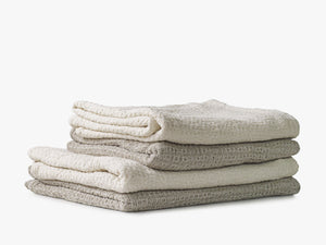 Pile of light waffle blankets, natural linen