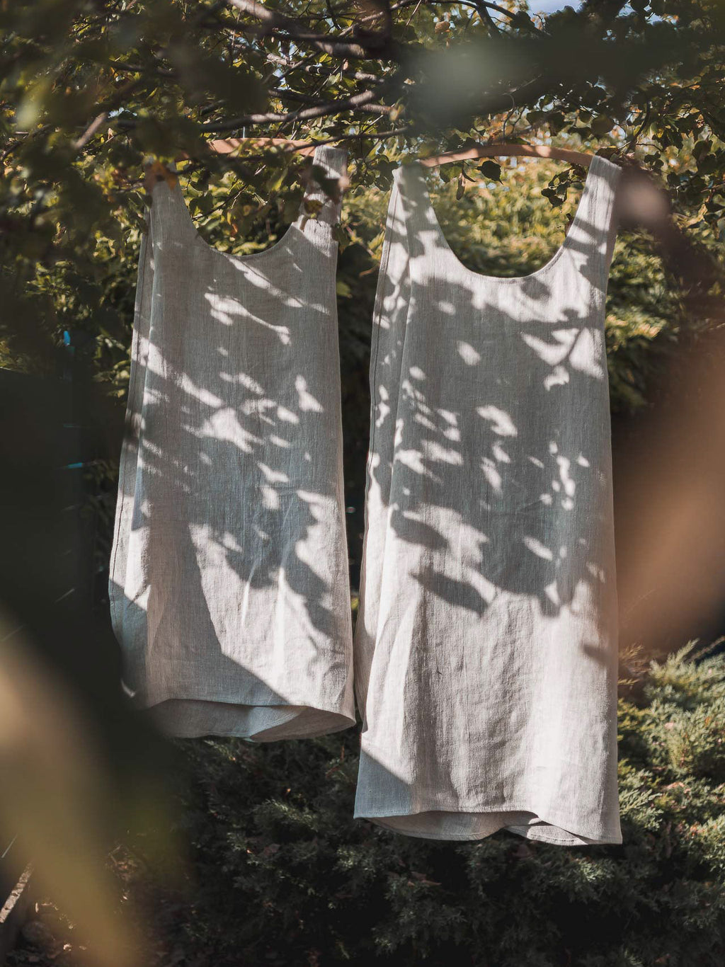 Linen Crossback Japanese Apron hanging on a tree in nature