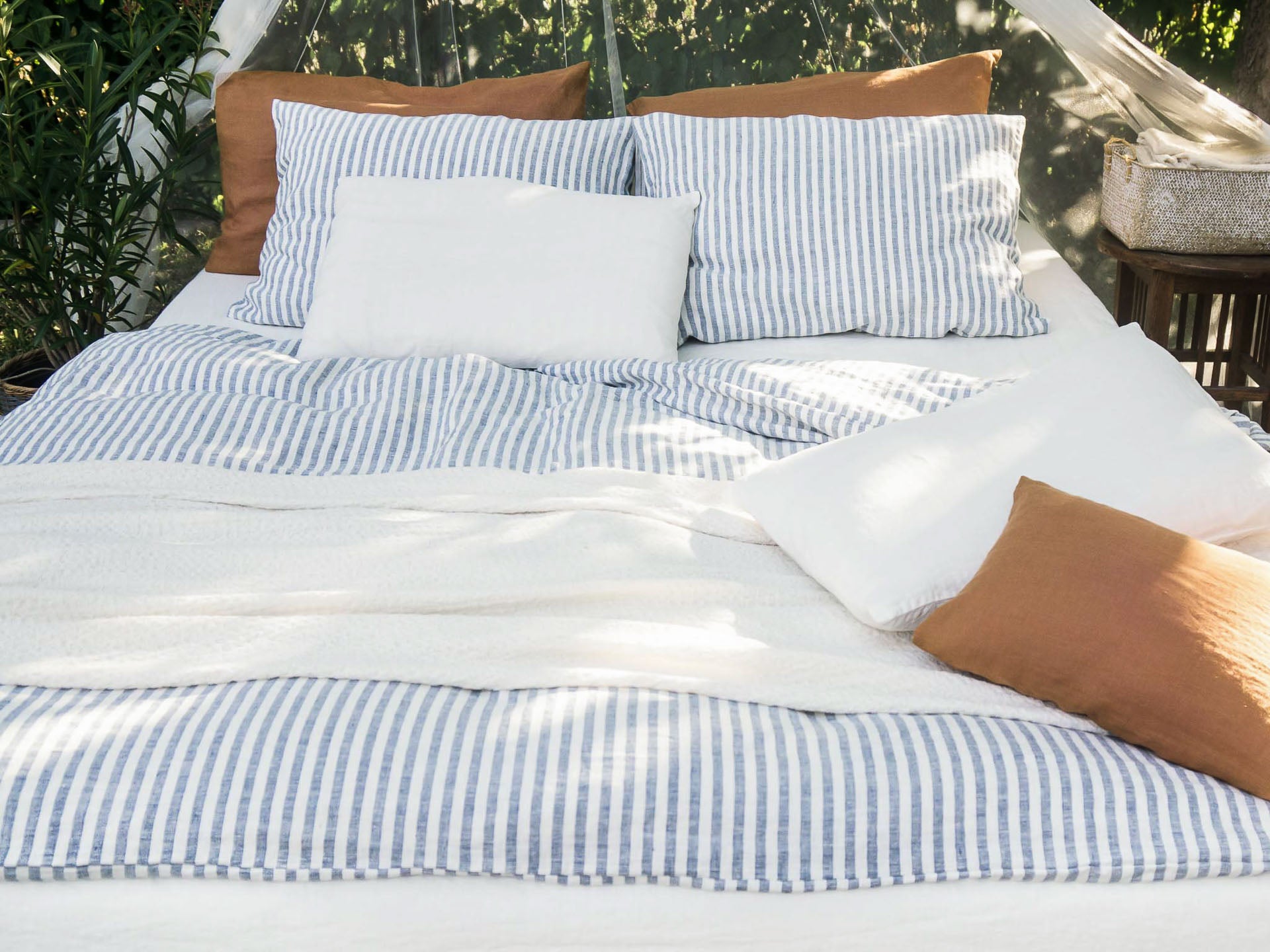 Blue Striped Linen Bedding set outdoor with a net