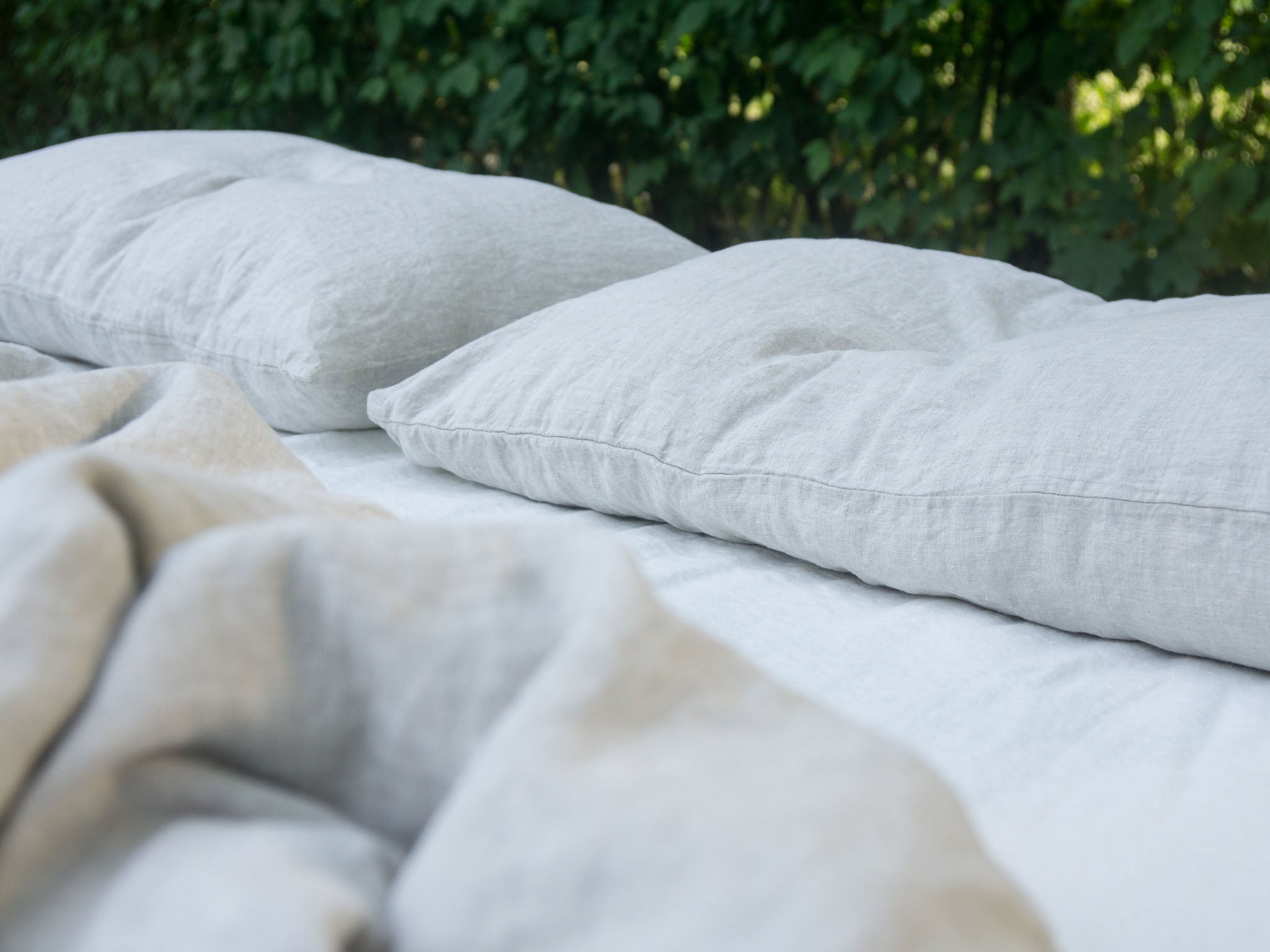 Pure Washed Linen Bedding on Made Bed Outdoors